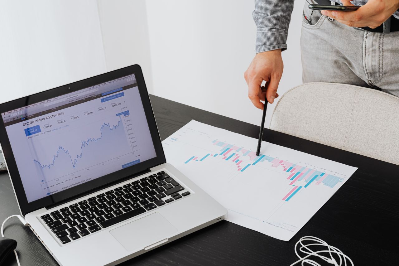 services-04 Person analyzing cryptocurrency data using a laptop, highlighting financial insights.